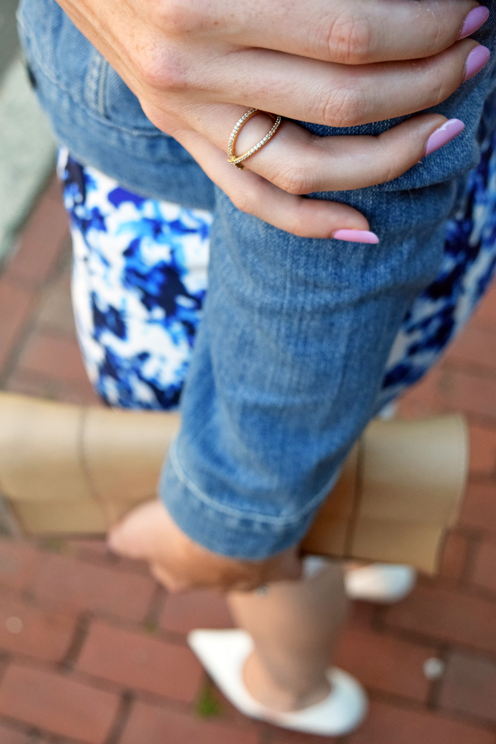 pink nails and gold criss-cross ring