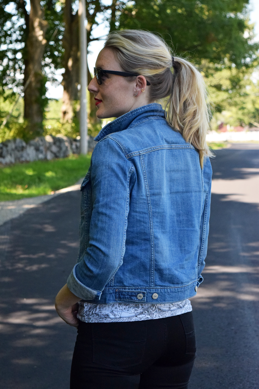 denim jacket with graphic tee and black jeans