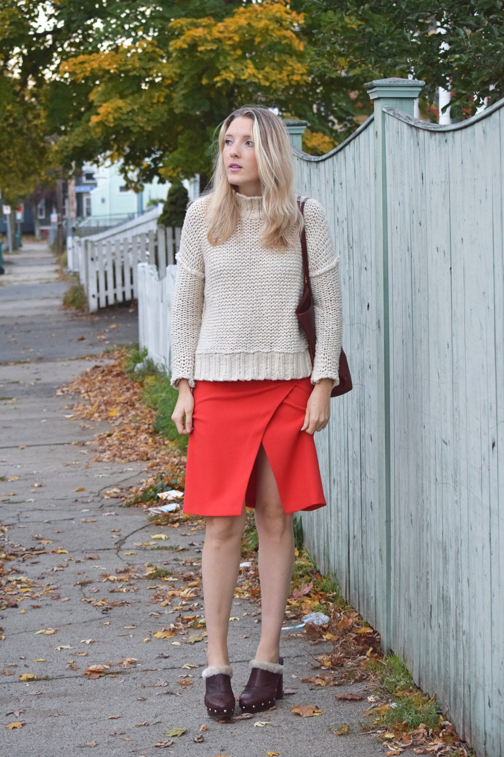 winter outfit with a sweater, skirt, and mules