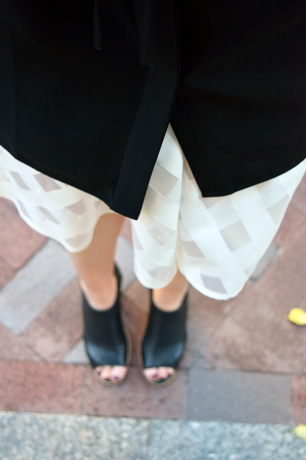 layering a dress over a skirt with ankle boots
