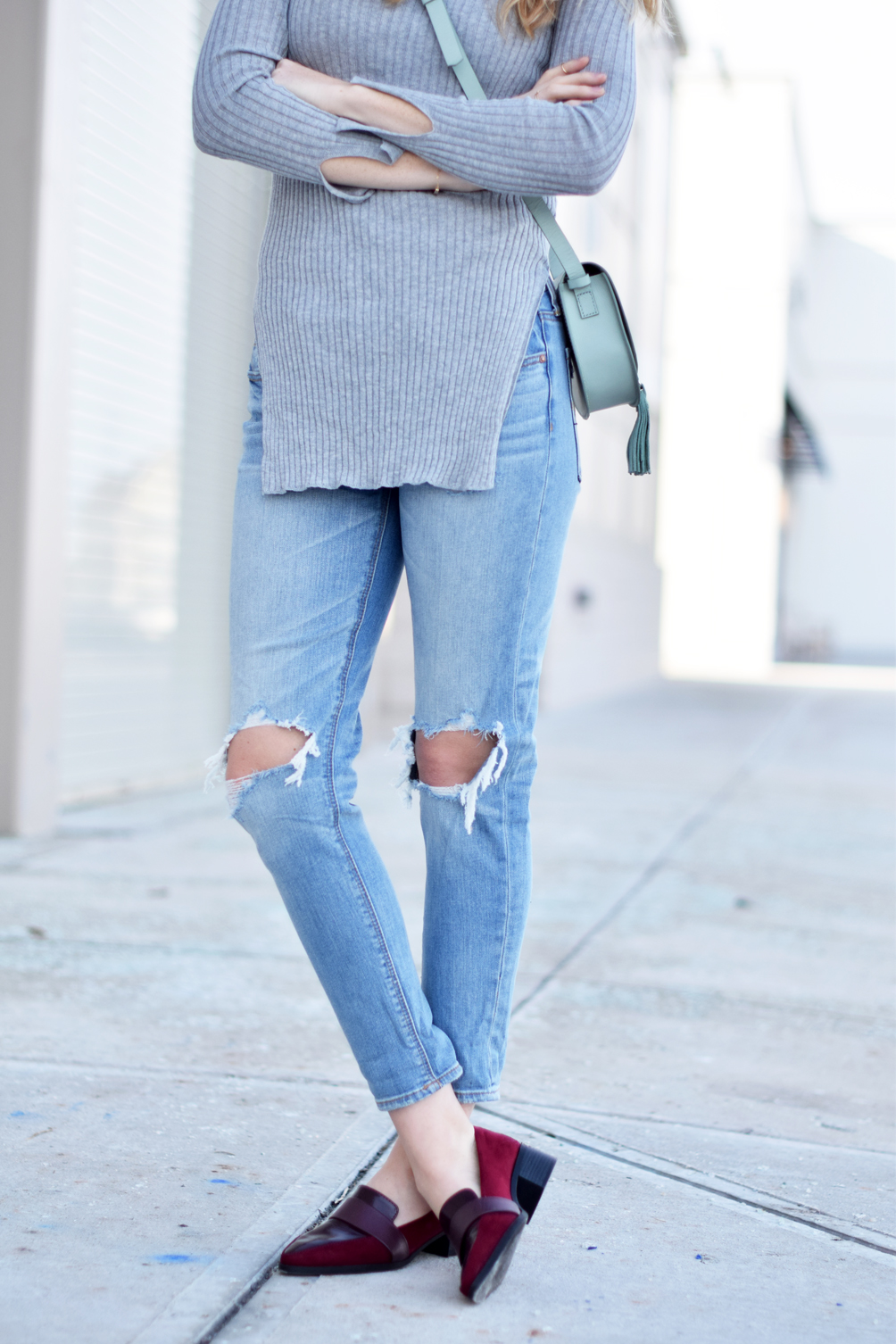 ripped knee jeans with a gray tunic - one brass fox