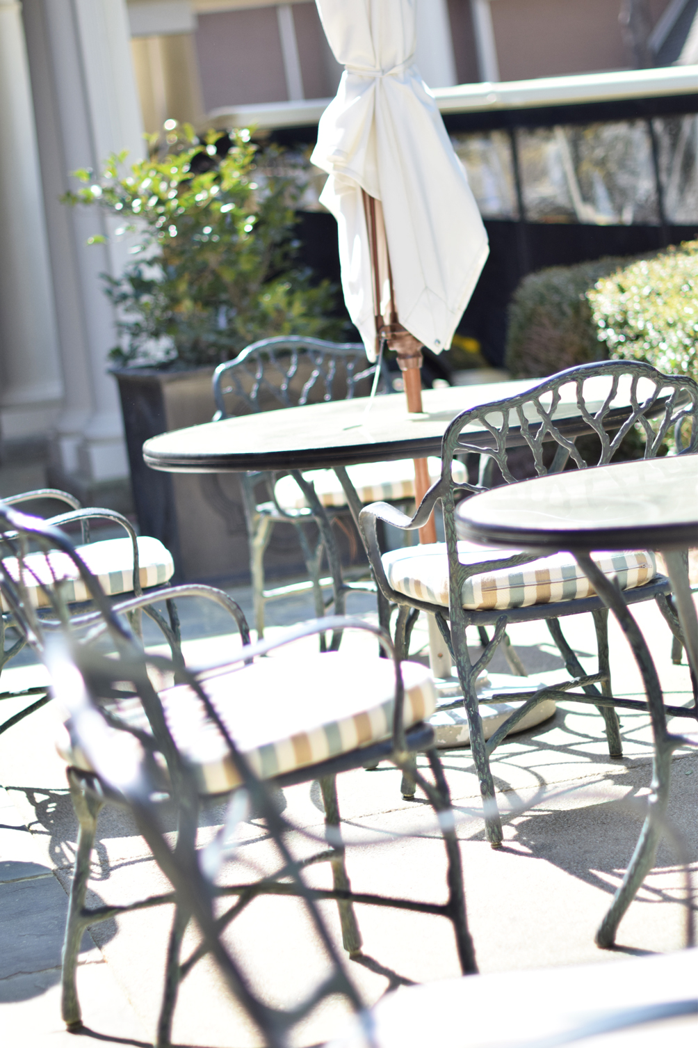 outdoor dining with wrought iron chairs - one brass fox