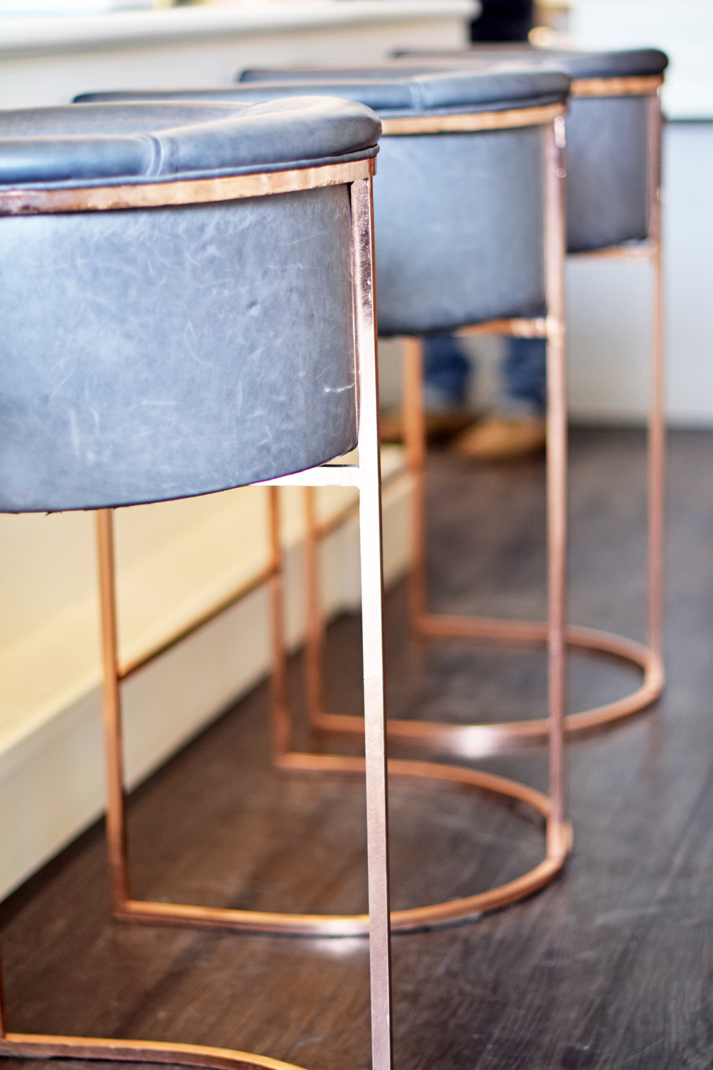 grey leather + copper bar stools - one brass fox