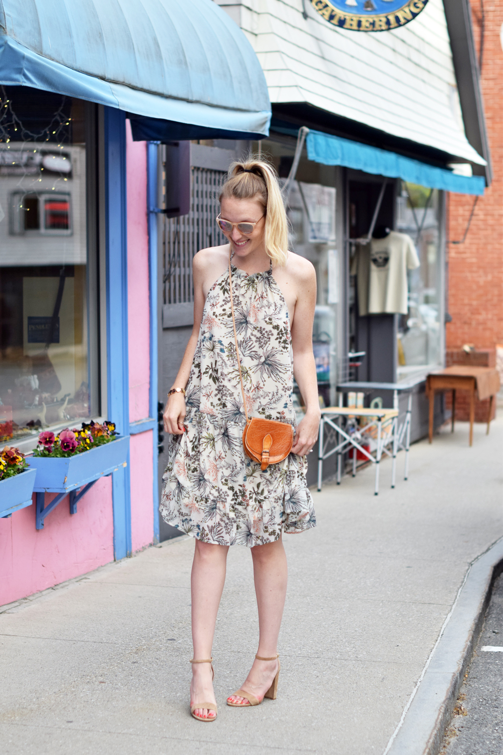 floral print halter dress with a tan crossbody and suede black heel sandals, sprint style outfit inspiration, leslie musser of one brass fox