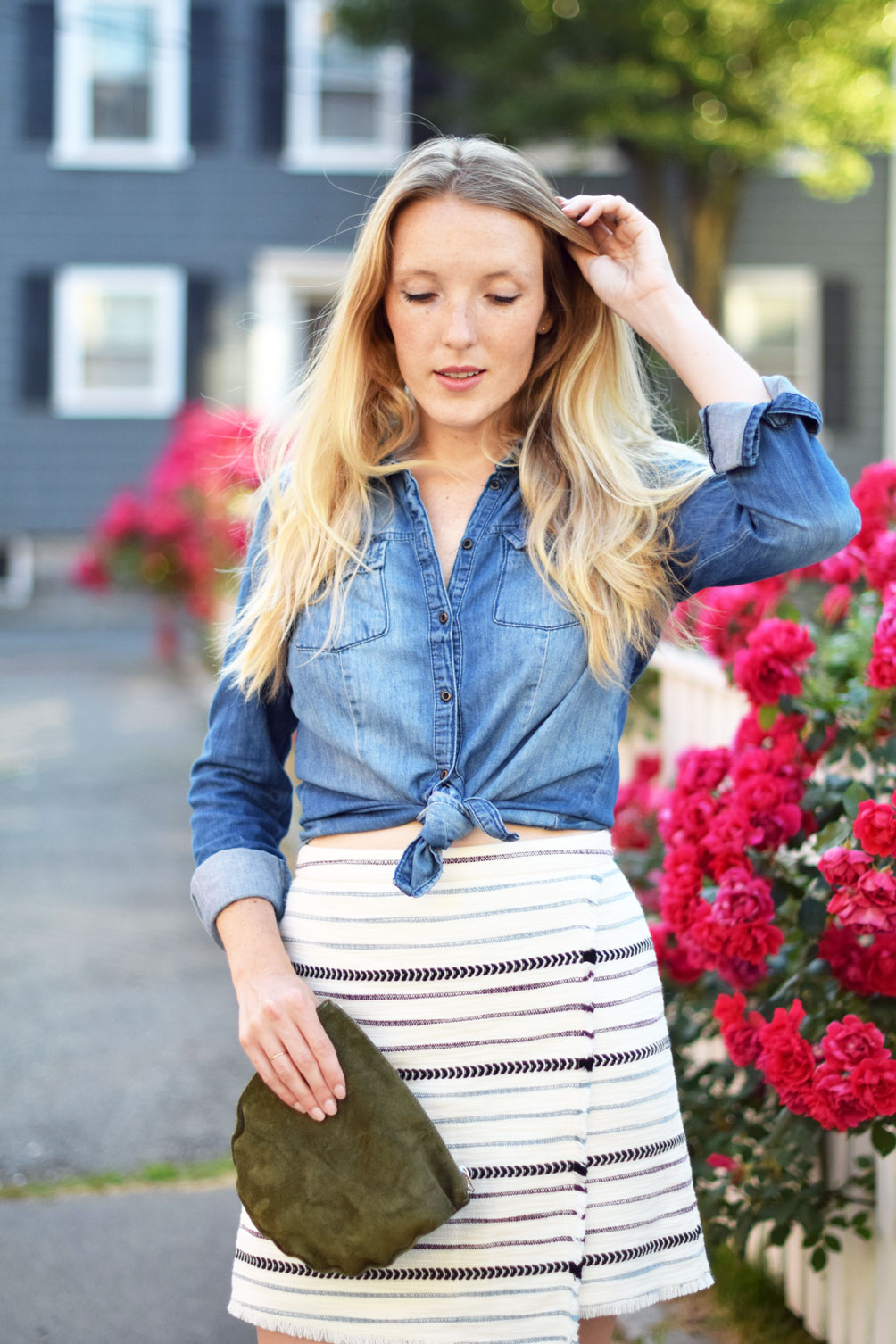 fashion blogger Leslie Musser of one brass fox wears a summer date night look of this chambray shirt, striped fringe wrap skirt, and suede mules