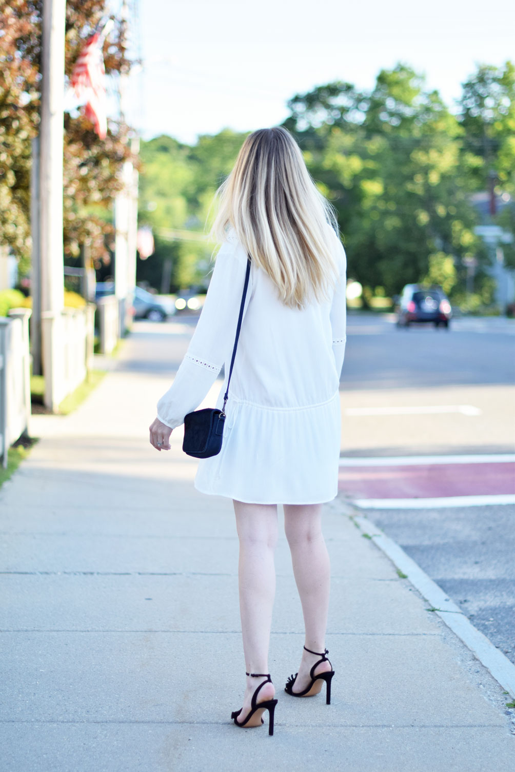 Leslie Musser of one brass fox shows off a summer LWD in this boho drop waist dress with fringe sandals