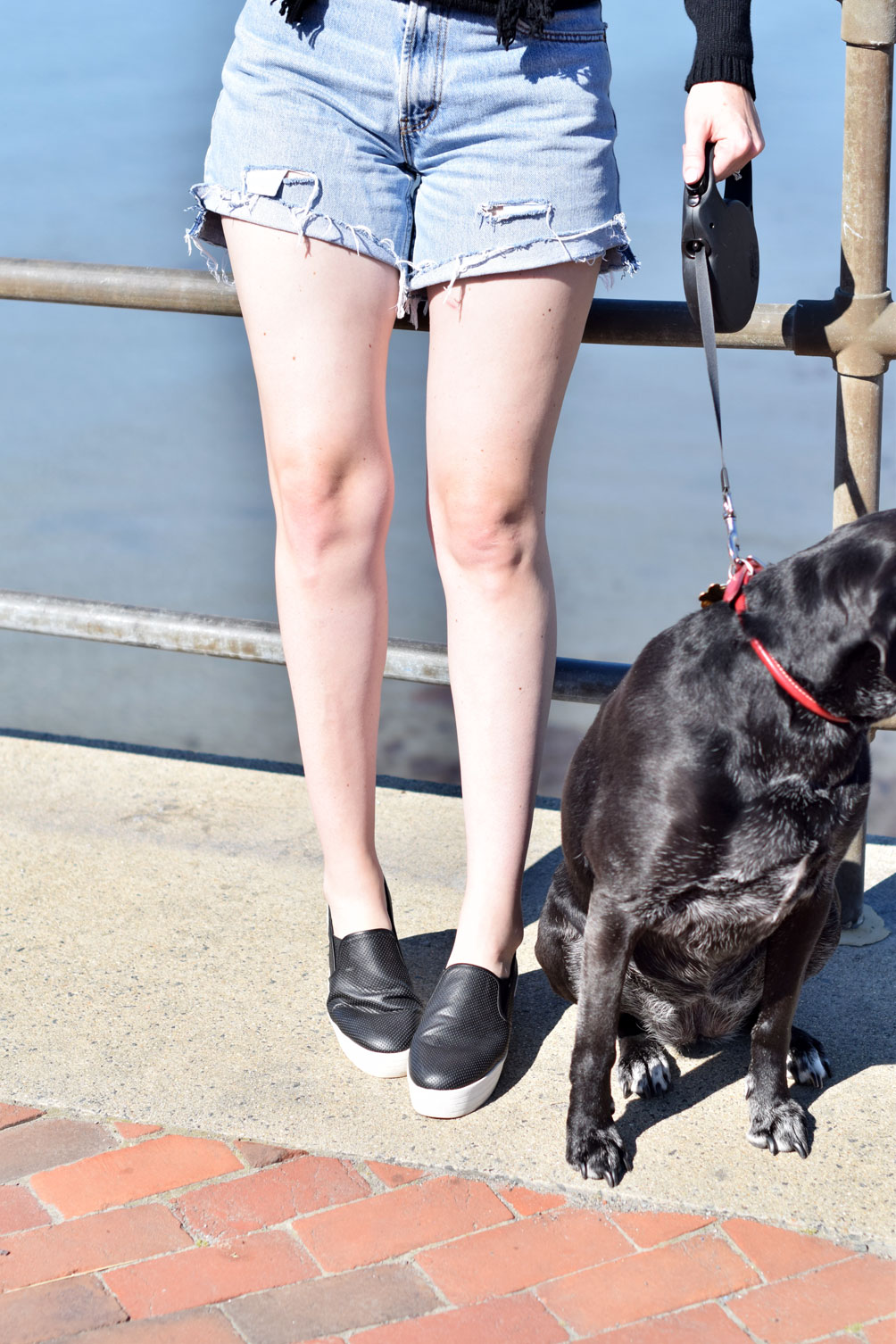 summer style from Leslie Musser of one brass fox wearing a fringe crewneck sweater with cutoff shorts and platform sneakers