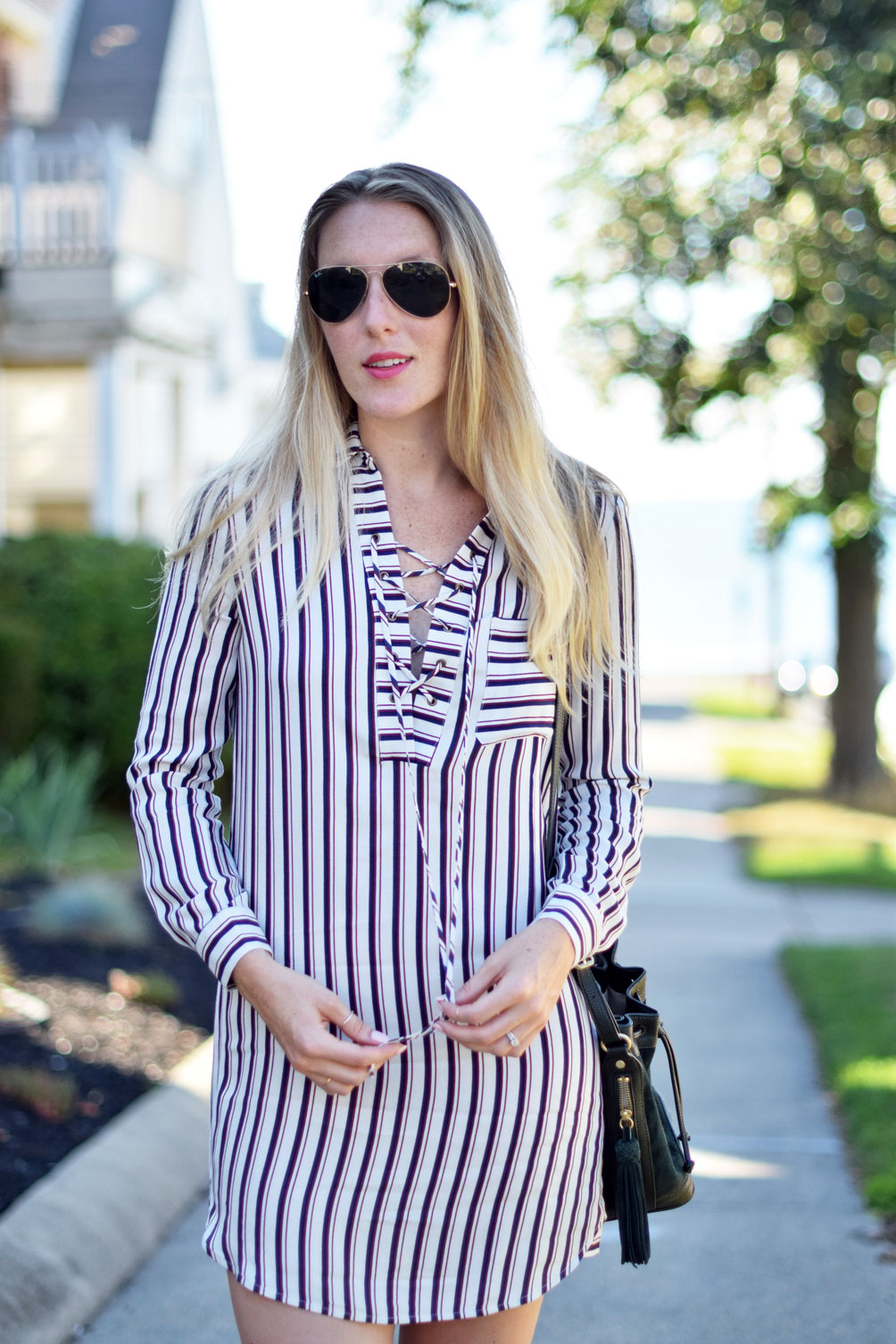 striped lace up shirtdress with tassel bucket bag and navy suede heels from Leslie Musser, fashion blogger at one brass fox