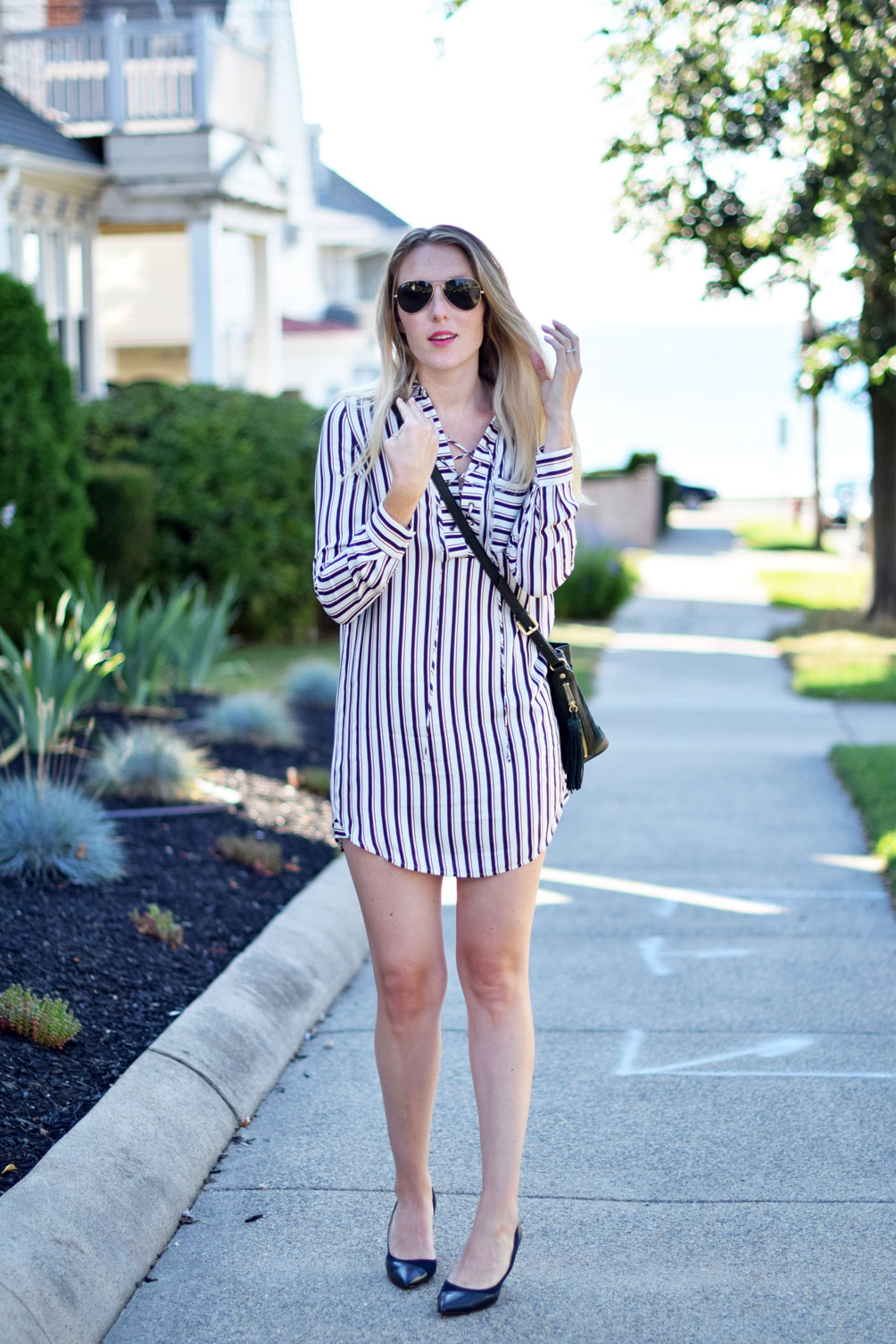 striped lace up shirtdress with tassel bucket bag and navy suede heels from Leslie Musser, fashion blogger at one brass fox