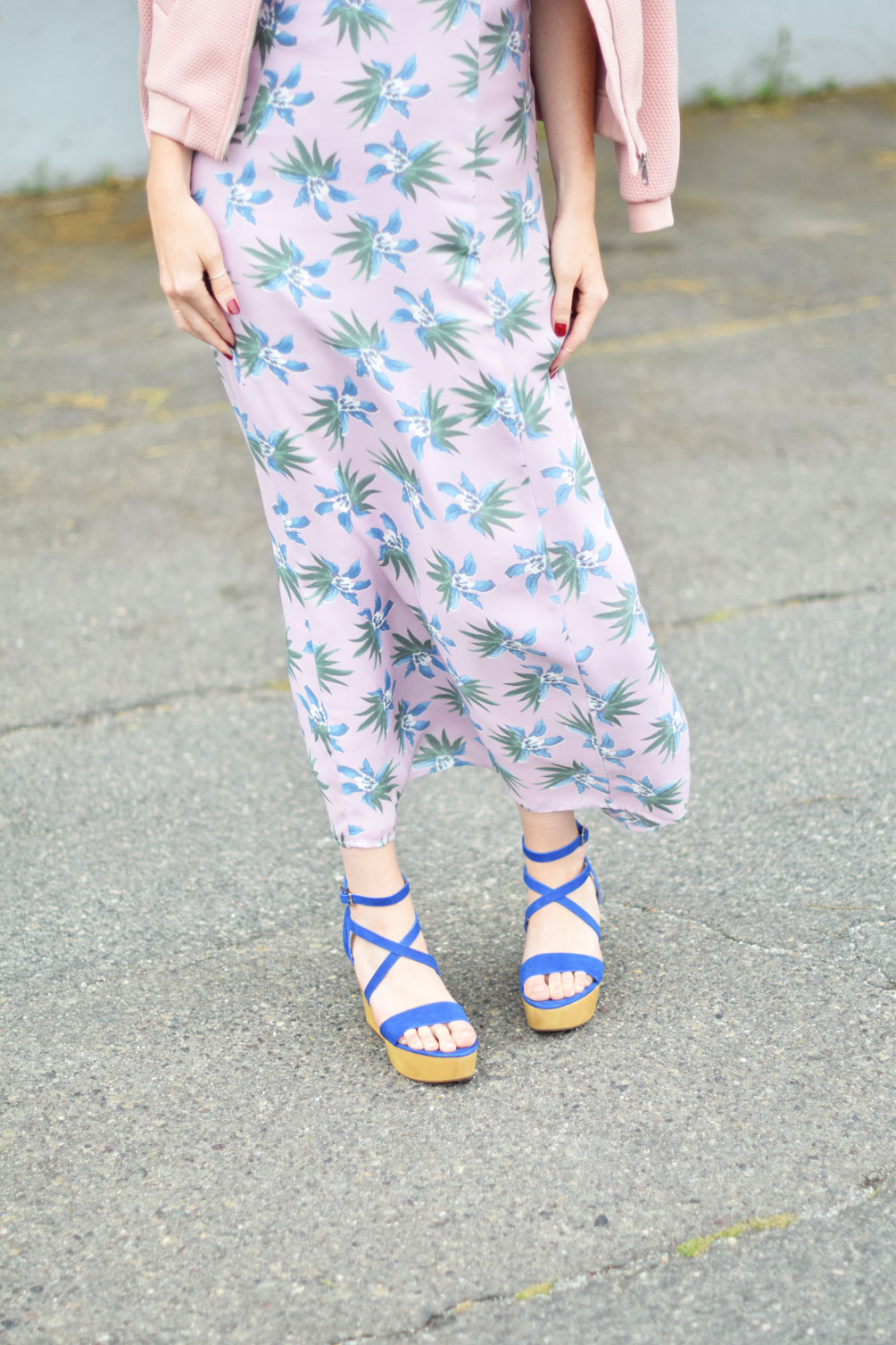 blush bomber jacket with a ruffle floral maxi dress and platform sandals on fashion blogger Leslie Musser of one brass fox