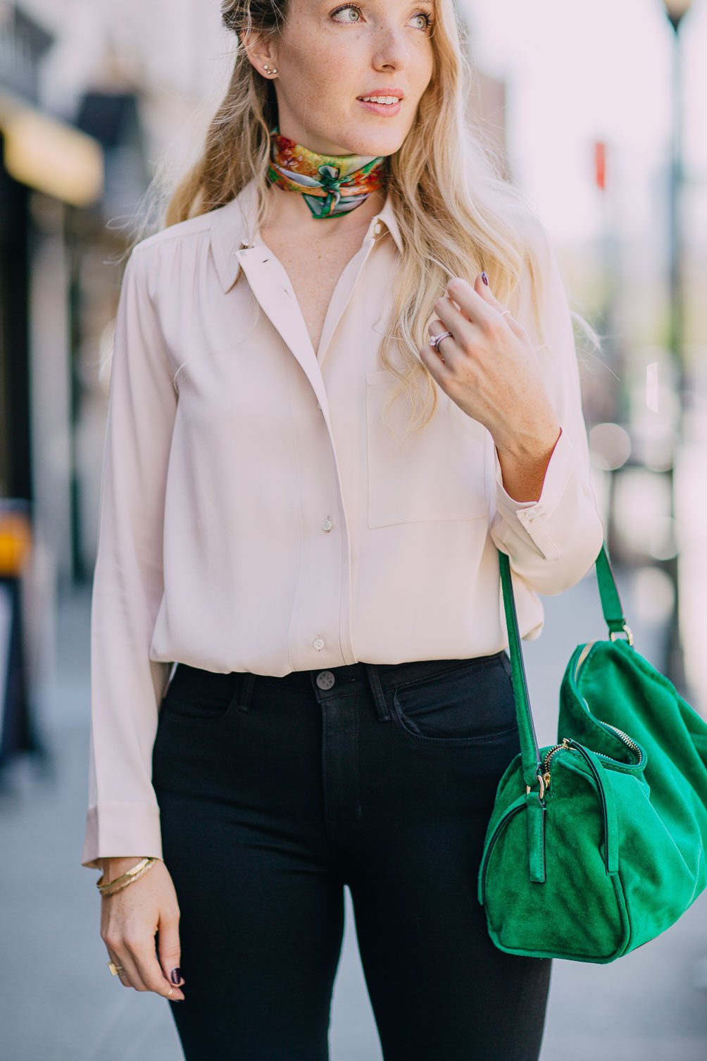 rose quartz silk blouse with jet black skinny jeans and an emerald bag on Leslie Musser one brass fox