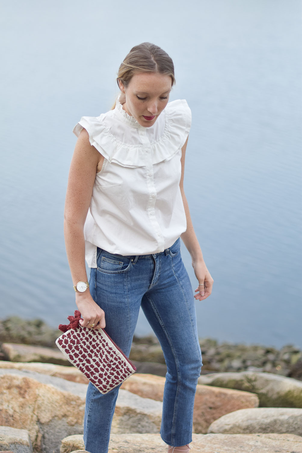 ruffled cotton blouse with crop jeans, blush kitten heels, and a beaded clutch on one brass fox