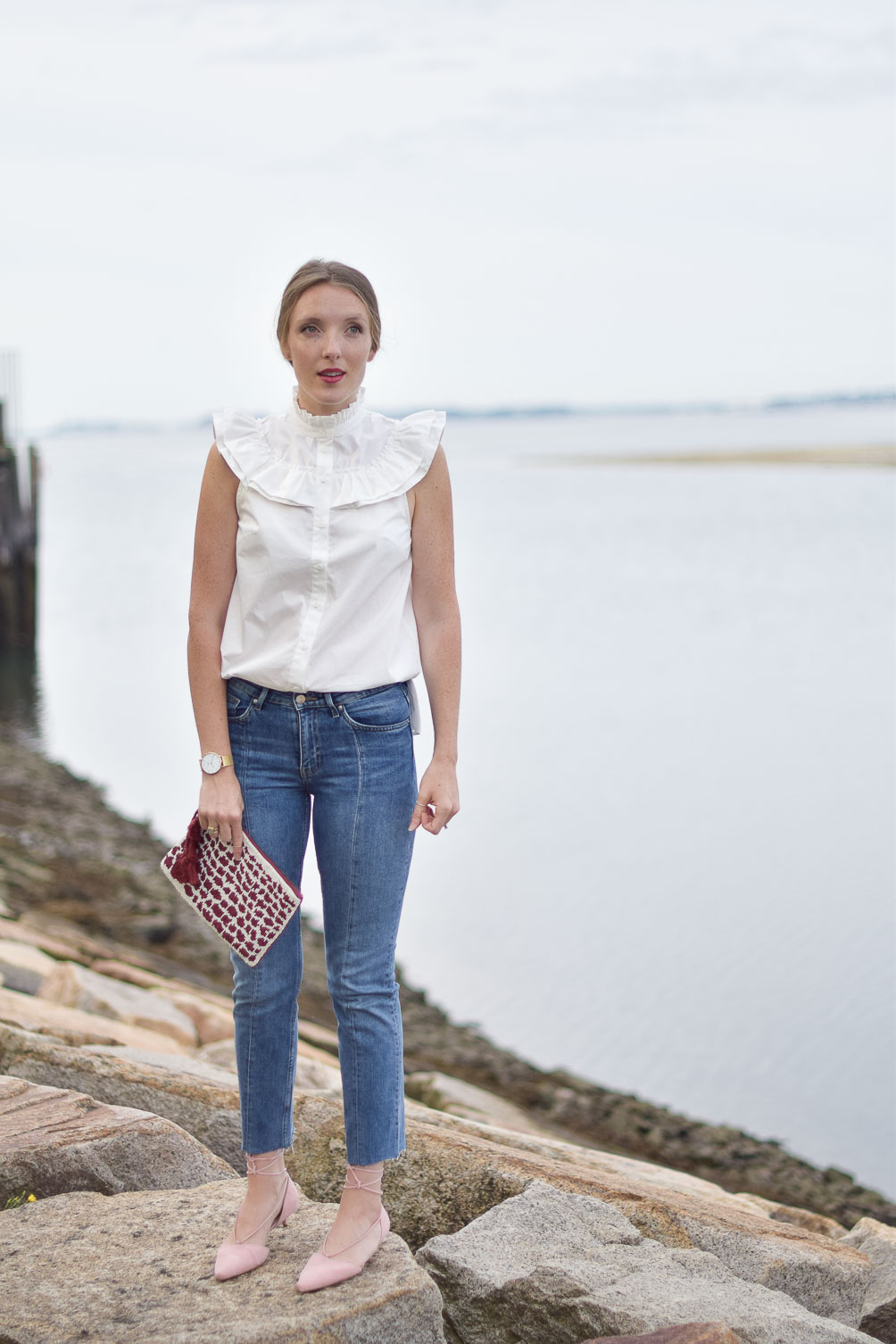 ruffled cotton blouse with crop jeans, blush kitten heels, and a beaded clutch on one brass fox