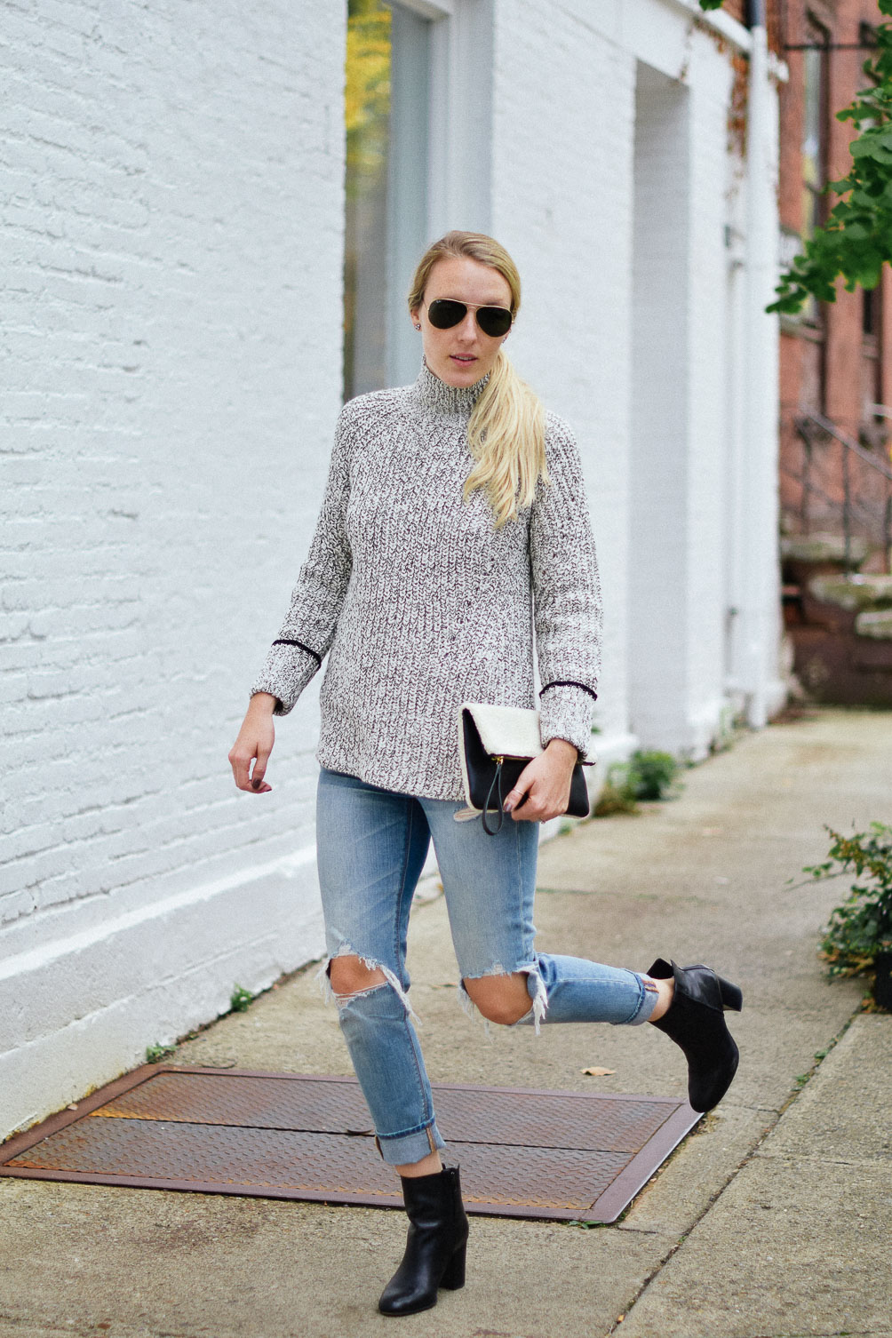 Leslie Musser cozy fall outfit with Topshop funnel neck sweater and American Eagle ripped jeans one brass fox