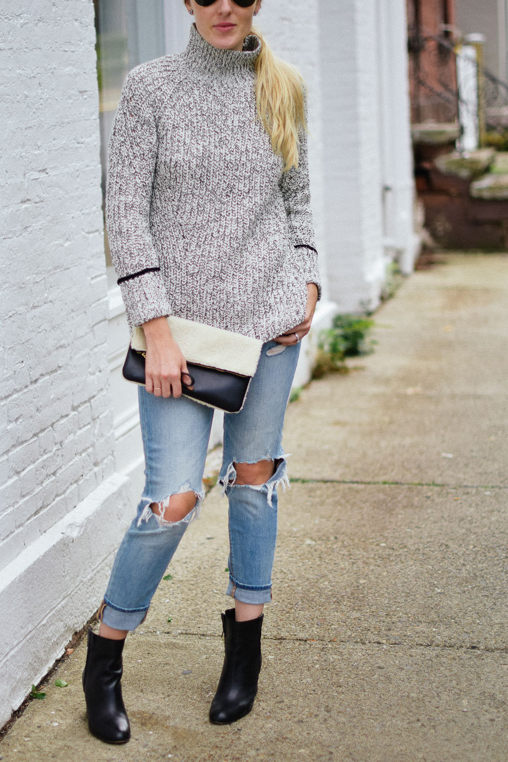 Leslie Musser cozy fall outfit with Topshop funnel neck sweater and American Eagle ripped jeans one brass fox