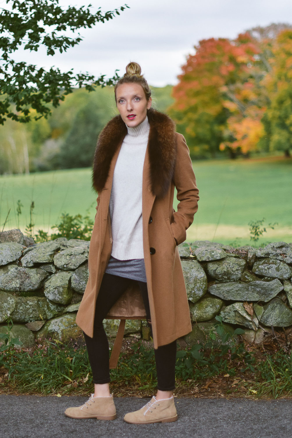 Leslie Musser wear fur coat layers with turtleneck sweater, black skinny jeans, and shearling lined ankle boots on one brass fox