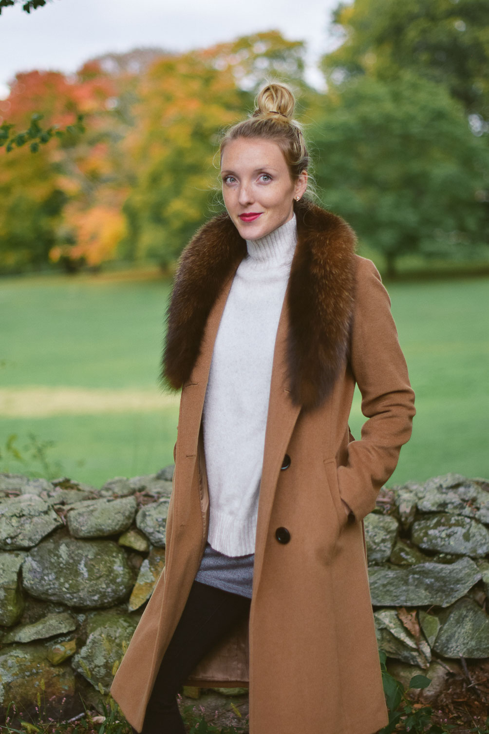 Leslie Musser wear fur coat layers with turtleneck sweater, black skinny jeans, and shearling lined ankle boots on one brass fox