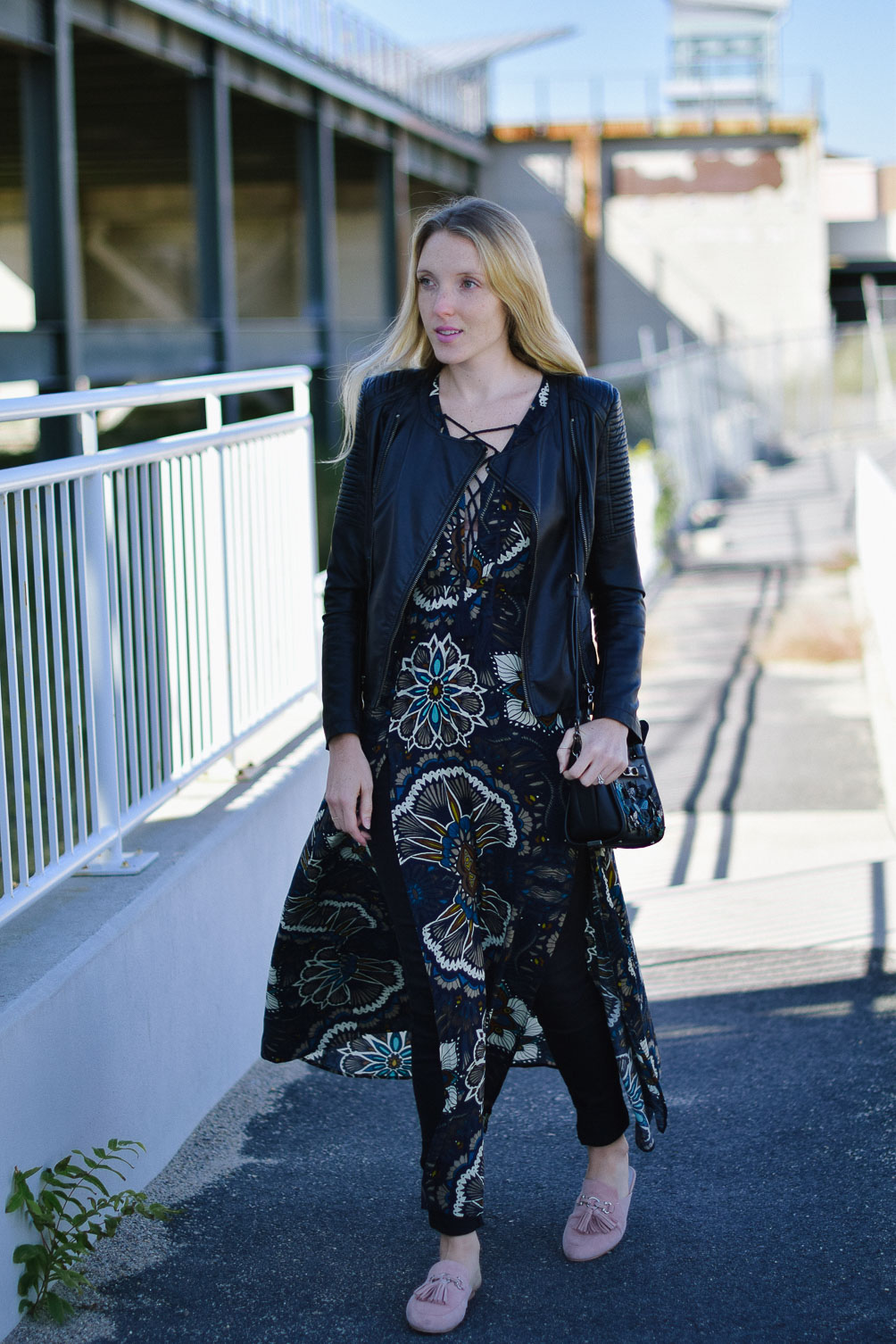 Leslie Musser shares tips on moto jacket styling for fall with a maxi dress, skinny jeans, and loafers on one brass fox