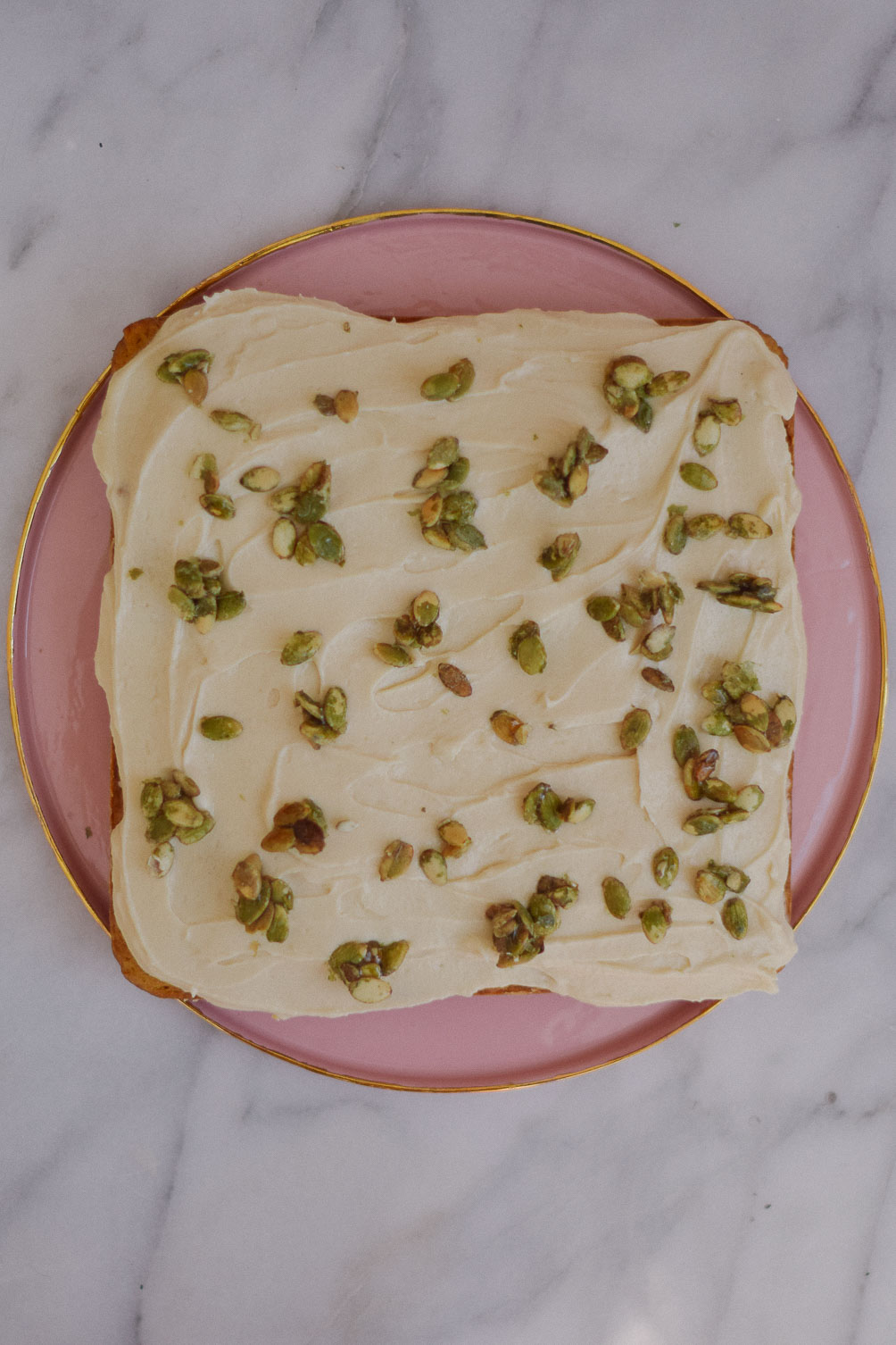 easy and delicious fall recipe ideas - sweet potato cake with candied pipits and cream cheese frosting on one brass fox
