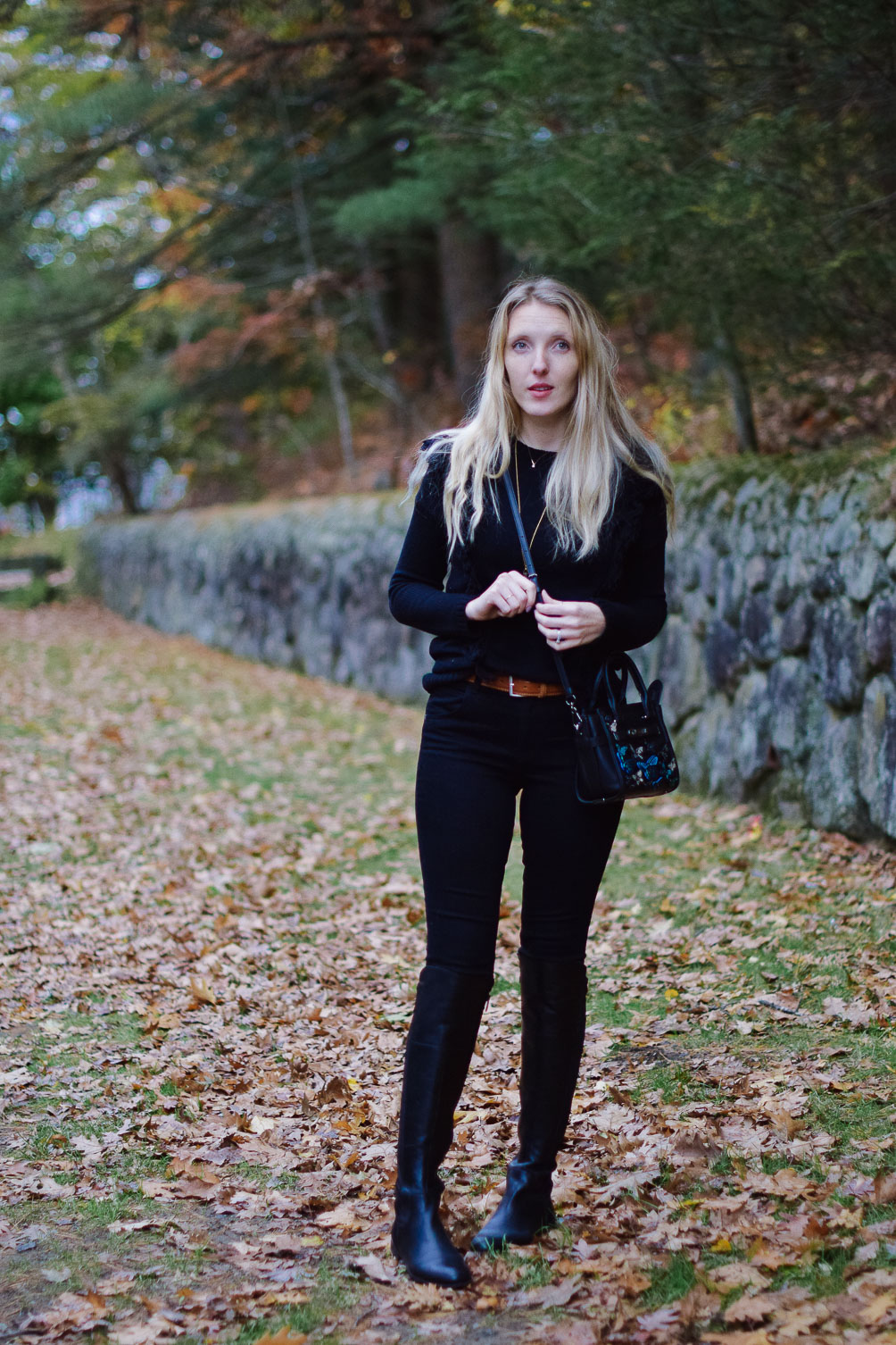styling black leather riding boots with a monochrome look for fall winter outfit inspiration