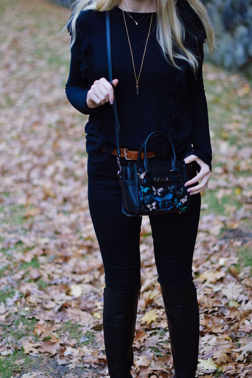 styling black leather riding boots with a monochrome look for fall winter outfit inspiration