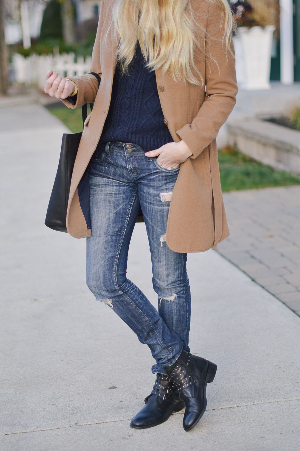 styling a camel winter coat with felt fedora, cable knit sweater, distressed boyfriend jeans and buckle boots