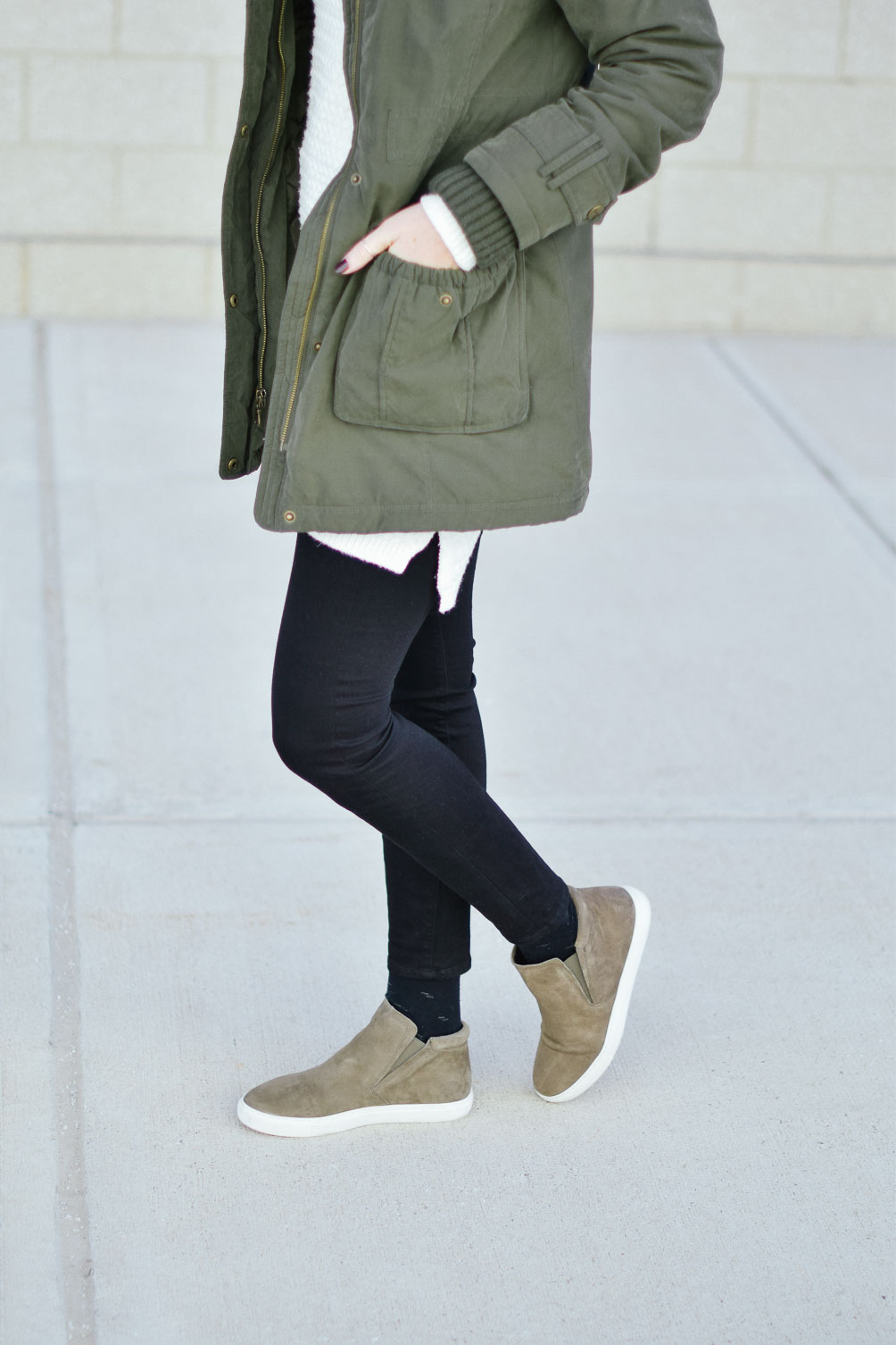 styling a green fur trim parka with this sweater dress over dark skinny jeans and olive suede sneakers
