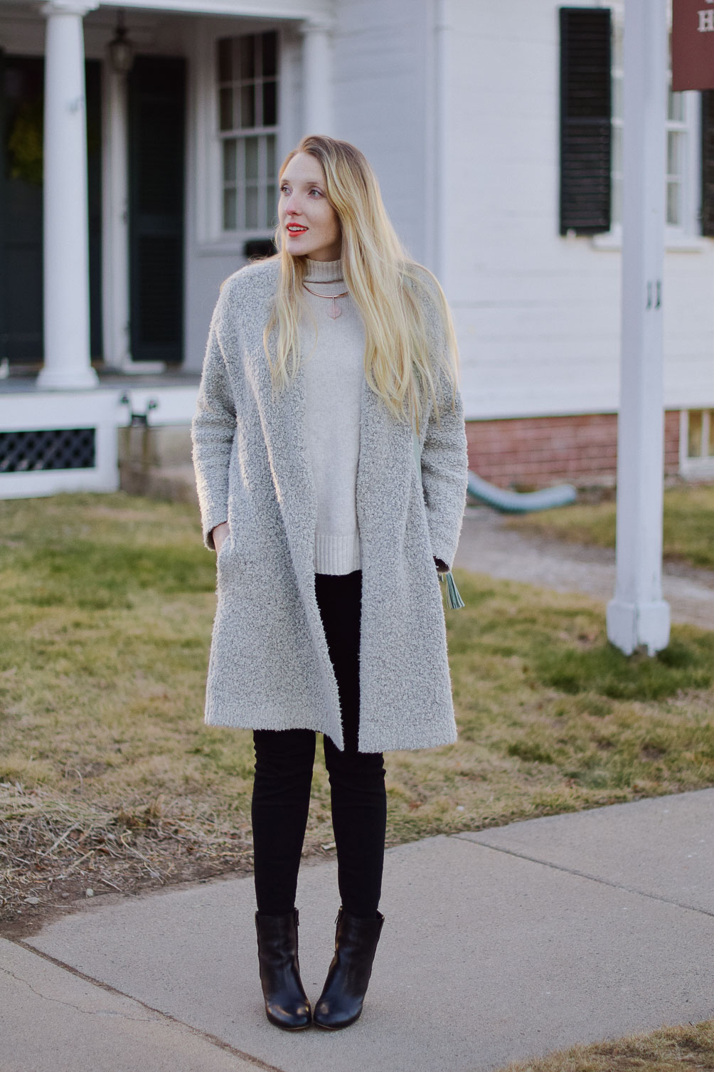 styling a coatigan layered over black skinny jeans and turtleneck sweater with black leather booties