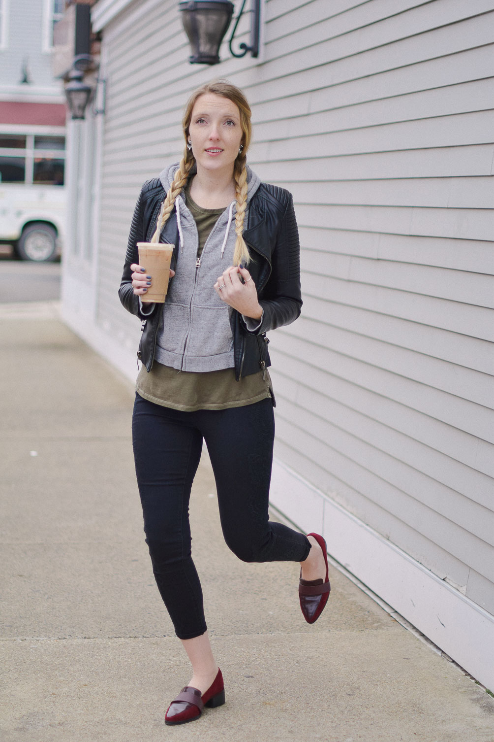 styling black embroidered denim with a vegan leather jacket and oxblood block heel loafers