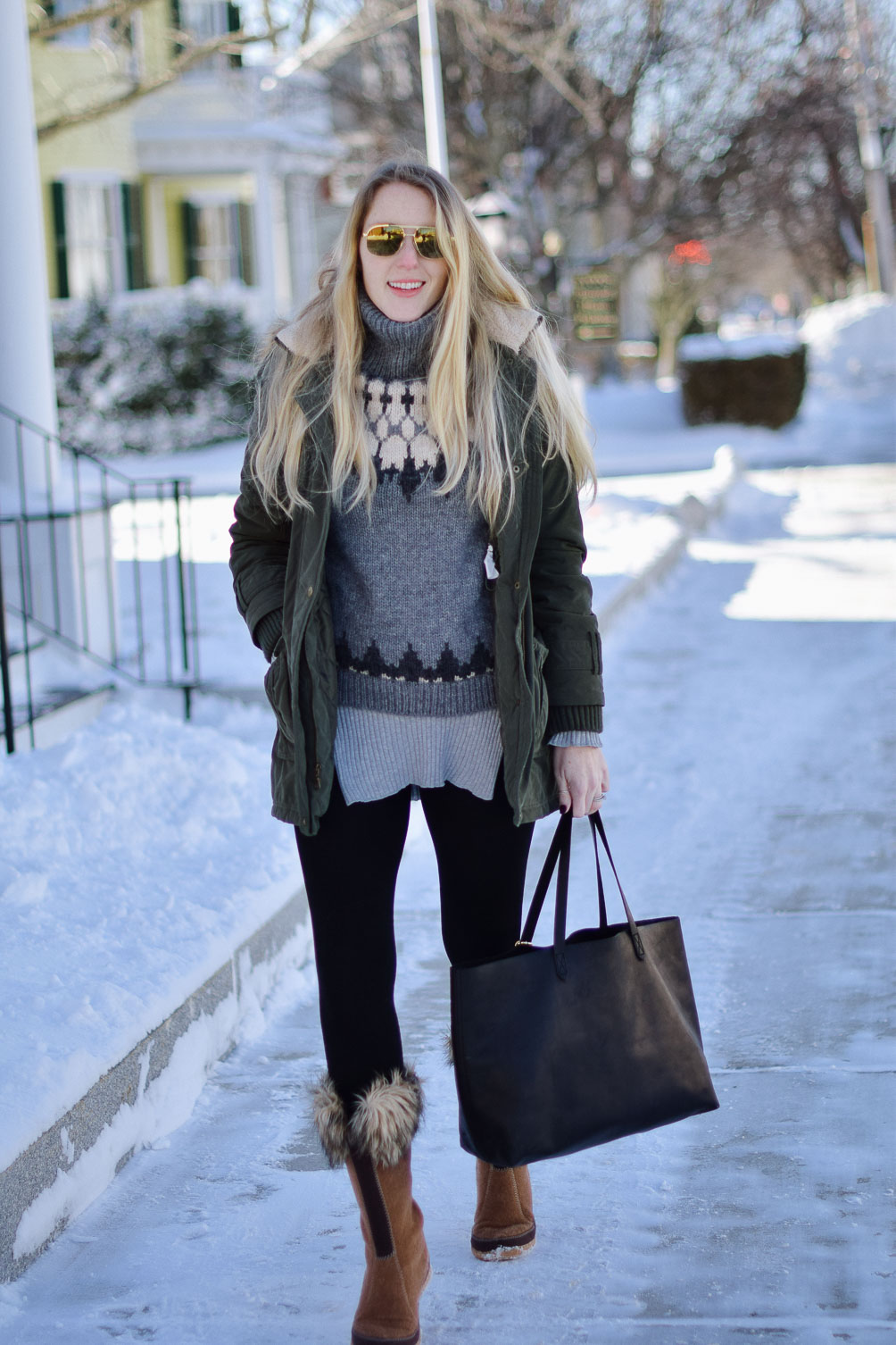 styling wool winter boots with faux fur accents, a turtleneck sweater, and velvet lined leggings 