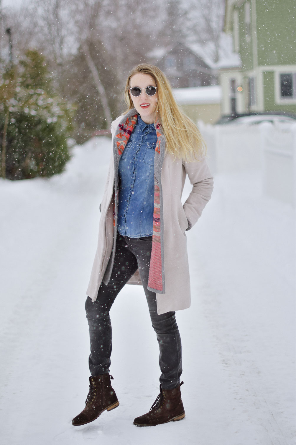 styling this cozy winter look with an aztec print sweater, chambray shirt, gray skinny jeans, and brown boots