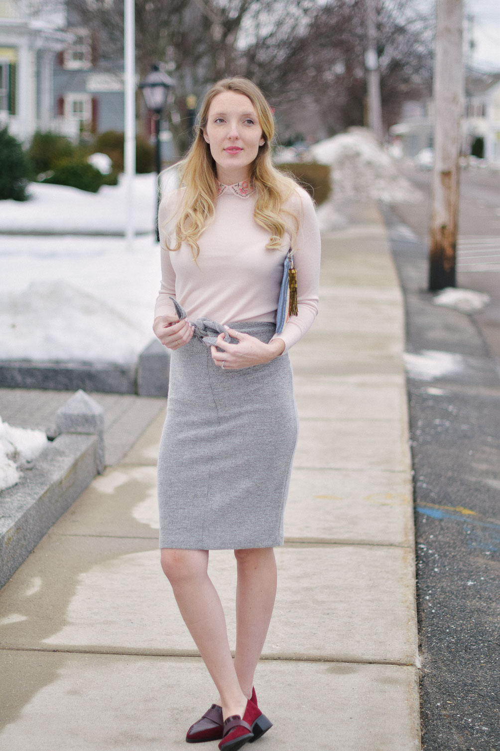 styling an embroidered collar sweater with tie waist skirt and burgundy loafers