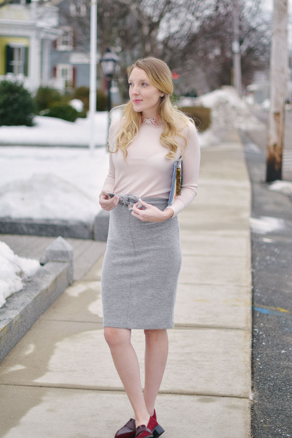 styling an embroidered collar sweater with tie waist skirt and burgundy loafers