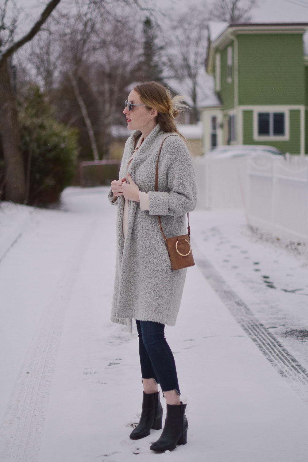 styling a faux suede mini bag with raw edge maternity jeans and an oversized cardigan