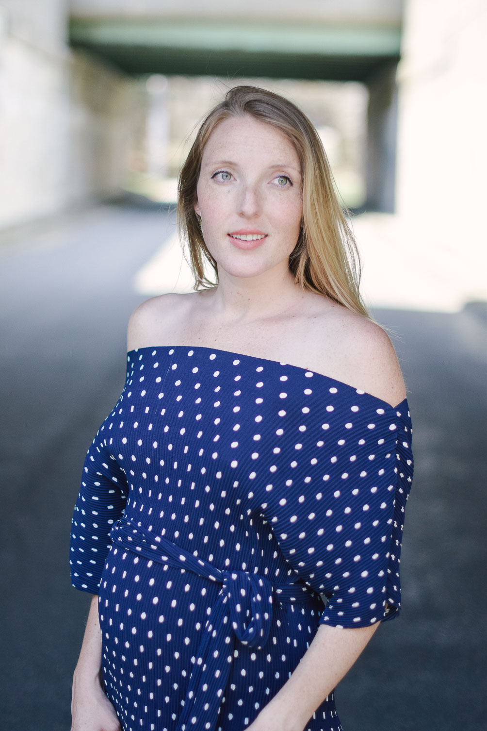 wearing spring maternity style with an off shoulder dress in polka dots