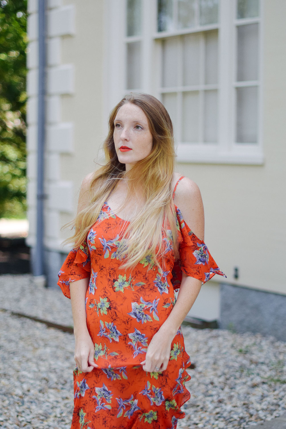 Leslie Musser styling an orange frill maxi dress with circle crossbody and suede mules on one brass fox