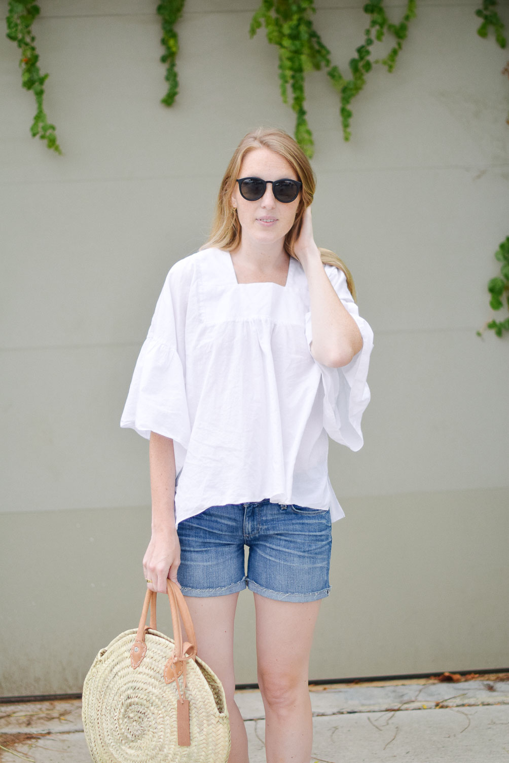 Leslie Musser styling the perfect straw market bag with Paige denim shorts and citron flats 