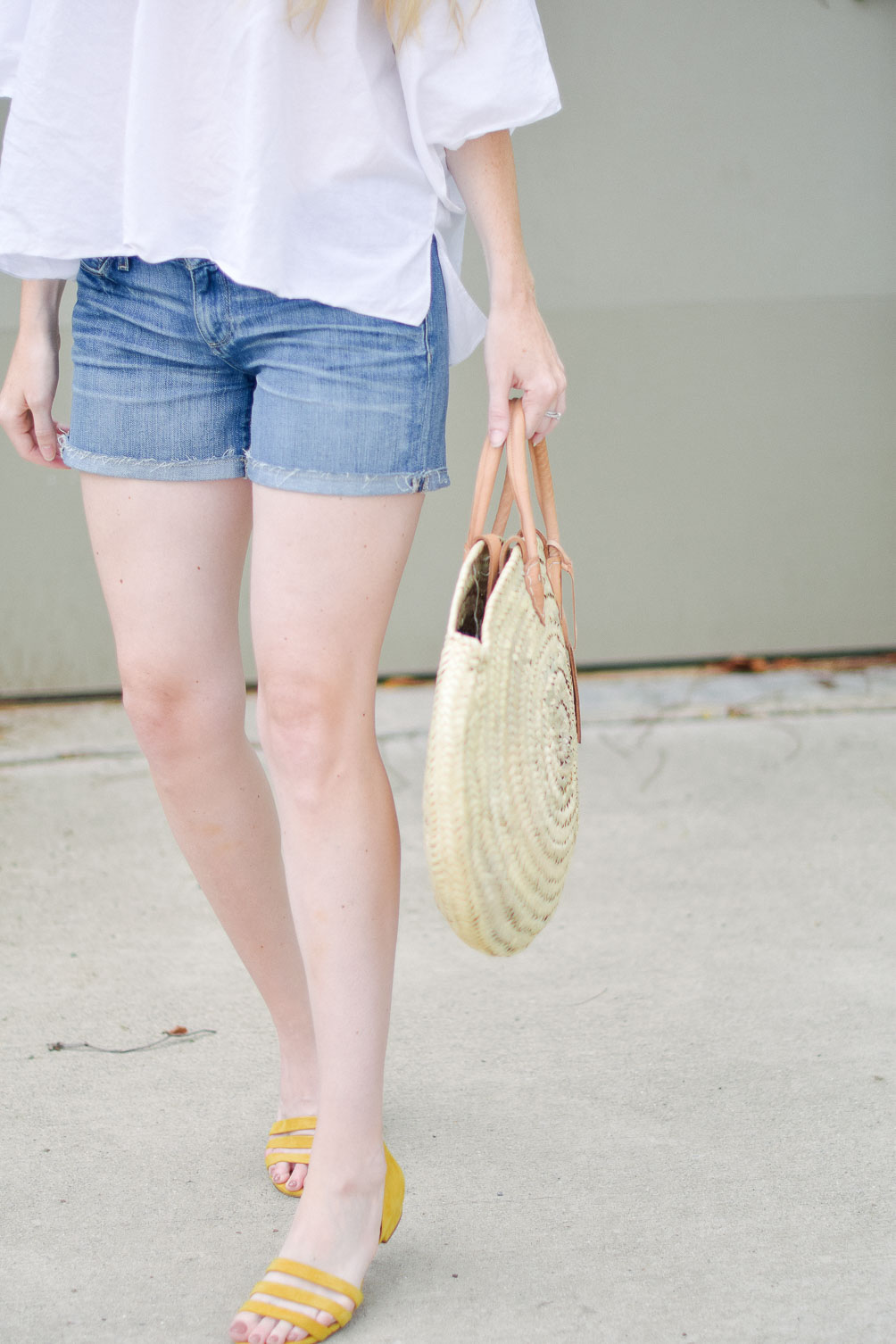 Leslie Musser styling the perfect straw market bag with Paige denim shorts and citron flats 