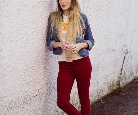 styling red skinny jeans for fall with a denim jacket and citron graphic tee