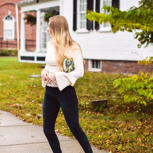 styling deep green velvet pants with a ruffled bell sleeve sweater and faux leather slides for top fall fashion trends