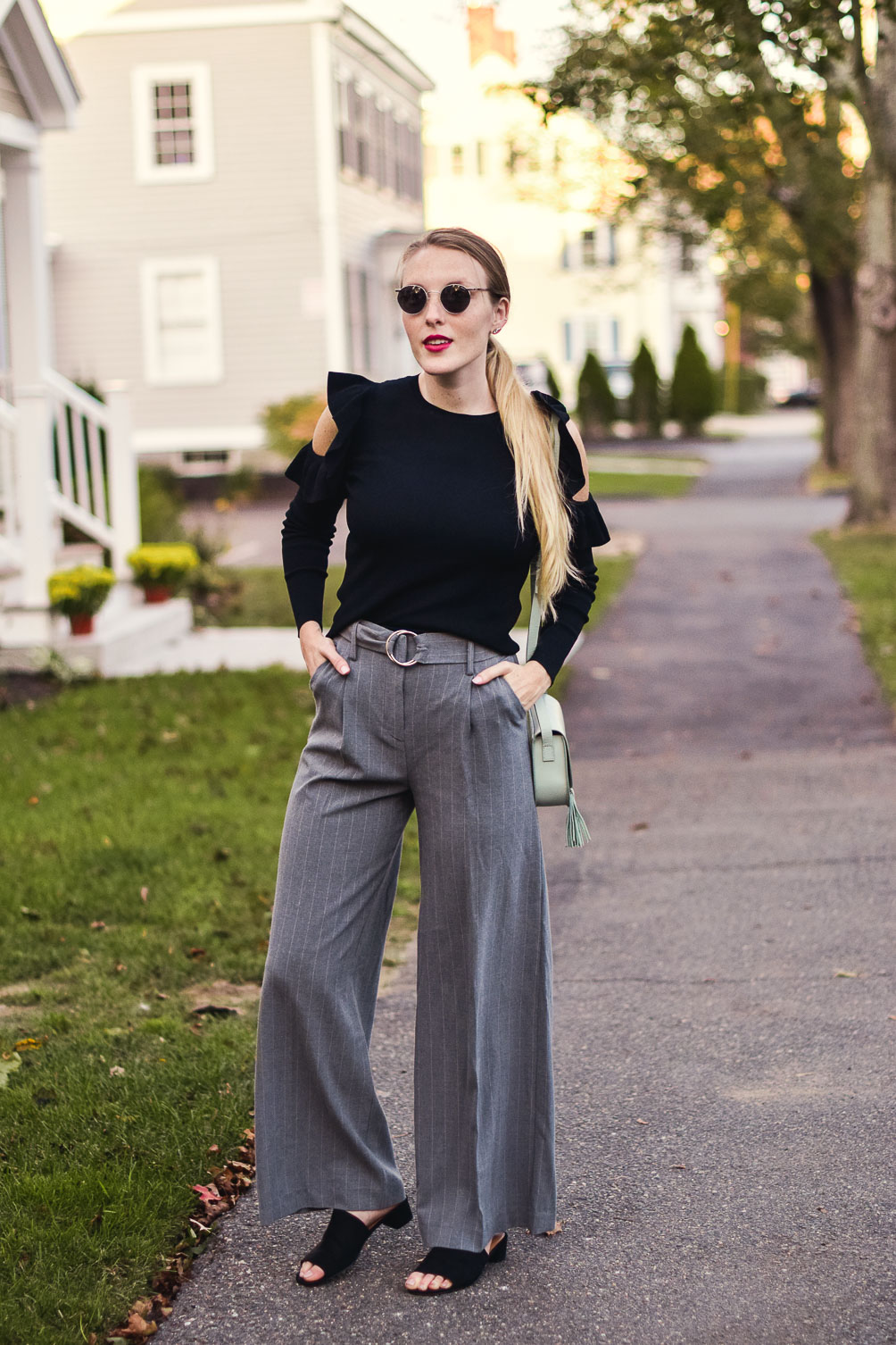 styling an easy classic holiday outfit for your work party with this cold shoulder ruffle sweater and pinstripe trousers