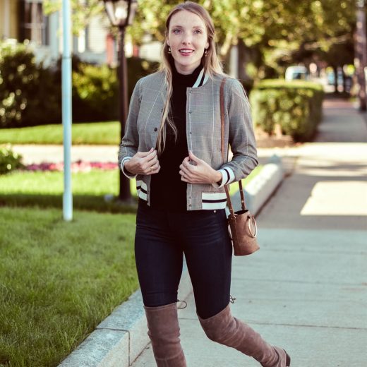 styling a Who What Wear varsity bomber jacket for fall with this black turtleneck, dark skinny jeans, and Stuart Weitzman over-the-knee boots