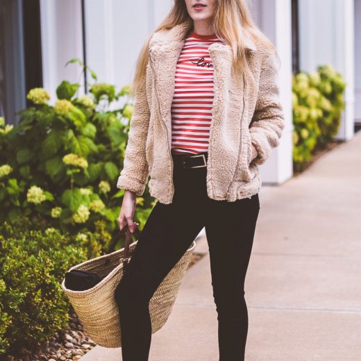 styling a teddy bear jacket as the best outerwear option for winter with a striped top and black skinny jeans