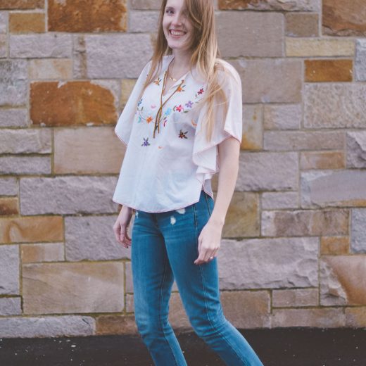 wearing an embroidered vintage top for spring with raw edge denim and cork platform sandals