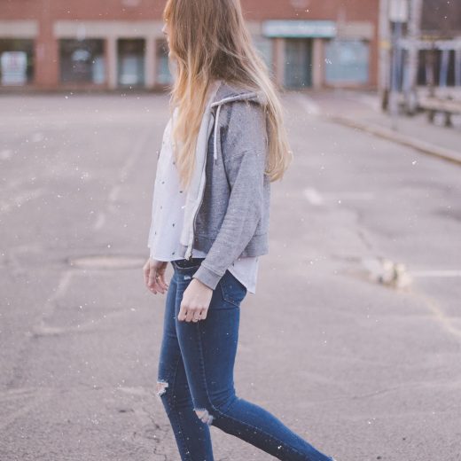 sharing my spring travel style with a gray hoodie, embroidered shirt, destroyed jeans and blush suede mules