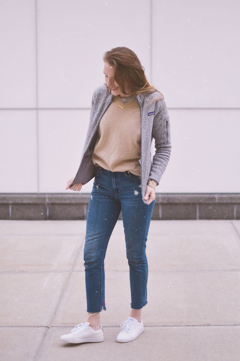 styling neutral layers for an easy, casual, and comfortable spring outfit with this cashmere sweater, raw hem jeans, and white sneakers
