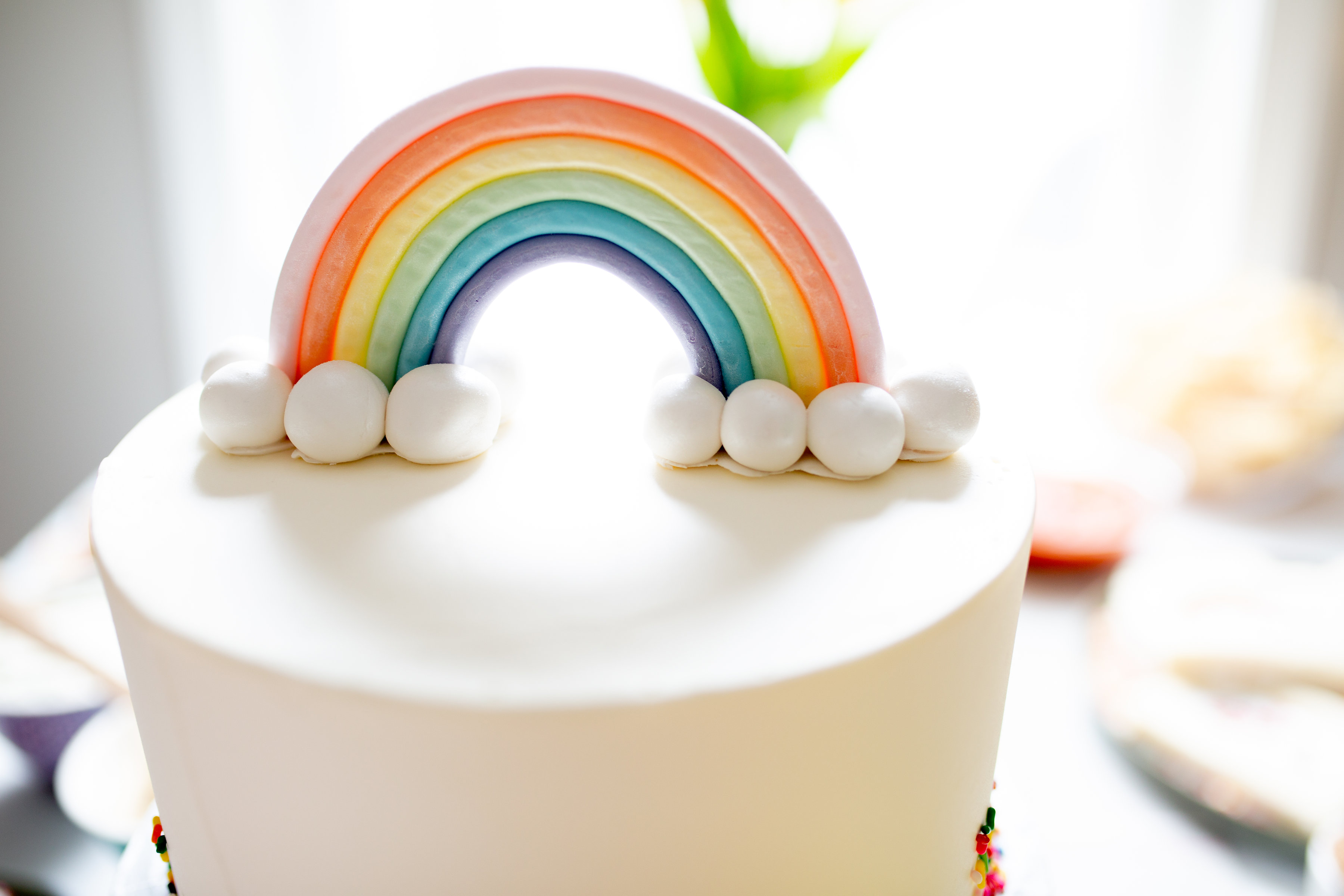 pastel rainbow birthday cake topper with clouds